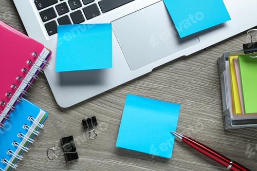 Preview: Different sticky notes, laptop and stationery on wooden table, flat lay
