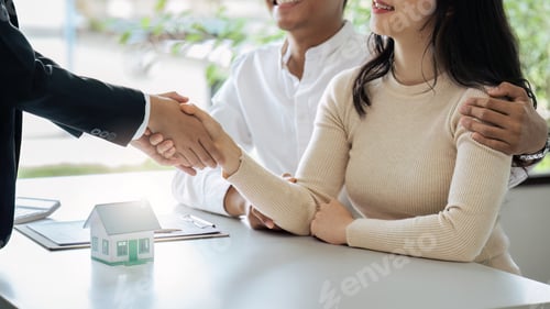 Preview: Happy couple of customers and real estate agent shaking hands after agreement success