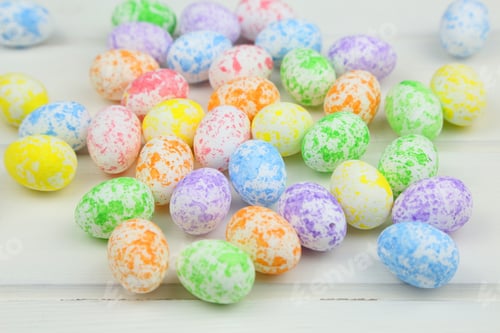 Colorful Speckled Easter Eggs on White Wood