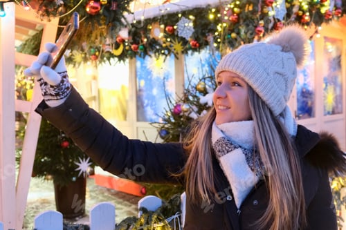 Preview: Selfie on a smartphone at a New Year's fair.