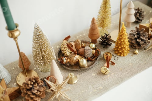 Preview: Christmas table decor. Stylish christmas golden trees, runner with stars, shiny baubles and candles