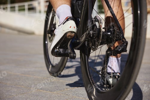 Preview: Closeup view on male bicyclist pedaling riding bike over city street