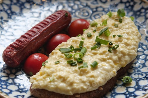 Preview: Breakfast plate with eggs and sausage on a decorative dish
