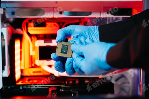 Preview: The technician is putting the CPU on the socket of the computer motherboard.