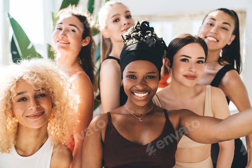 Preview: Multiethnic sportswomen smiling while taking selfie