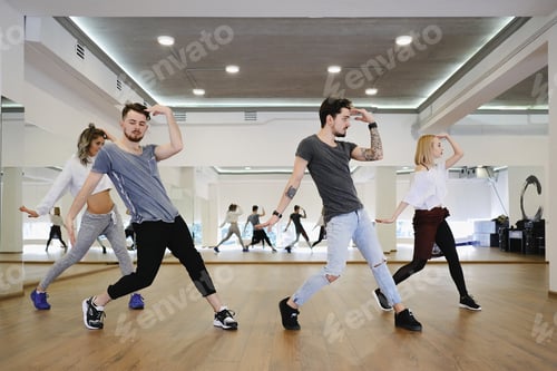 Preview: Group of young modern dancers dancing in the studio