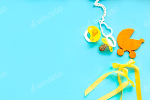 Preview: baby accessories on blue background, like soother, nipple, wooden clothes, wooden small baby stoller