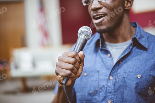 Preview: African-American male talking on the microphone at the church