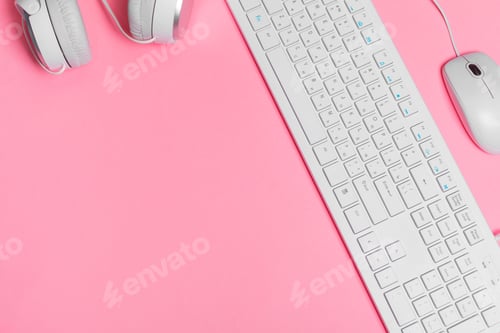 Preview: Woman's pink creative workspace with computer keyboard and supplies, top view