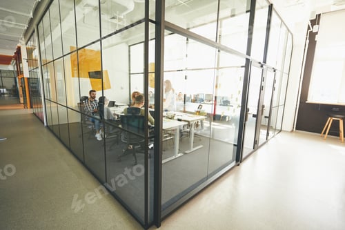 Preview: Industrious young people working in a cozy modern glass office