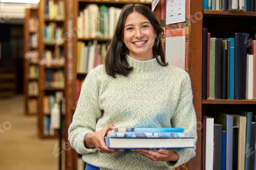 Preview: Paradise will be a kind of a Library. Shot of a young woman holding books in a library.