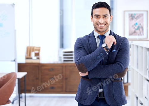 Preview: Shot of a handsome young businessman standing with his arms crossed in his office
