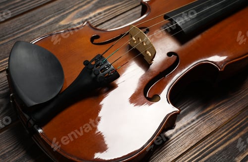 Preview: Classic violin on wooden background, closeup view