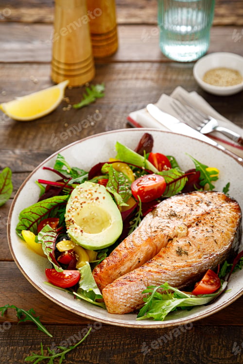 Preview: Salmon fish steak grilled, avocado and fresh vegetable salad with tomato