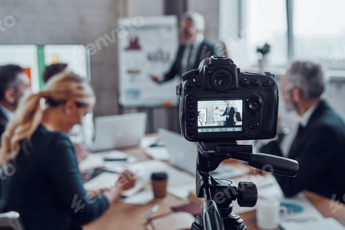 Preview: Modern business team discussing strategy while filming staff meeting in the board room