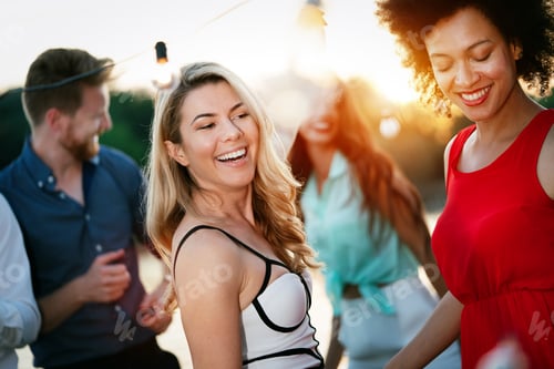 Preview: Group of beautiful people friends celebrating, dancing and having fun together outdoor