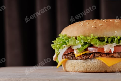 Preview: perfect tasty big cheeseburger on wooden table on brown background