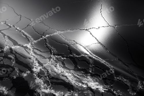 Preview: Grayscale shot of the texture of cracked frozen water surrface