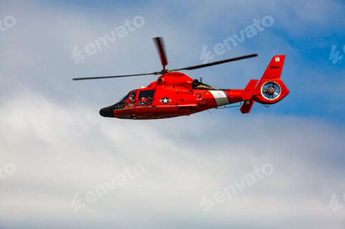 Preview: US Coast Guard helicopter hovering over the water in a demo of a rescue for a sea swimmer.