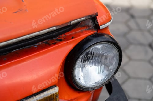 Preview: Red old Zaporozhets car in the yard on a sunny day.