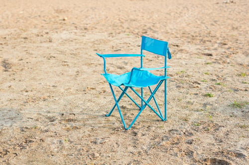 Preview: End of season, vacation and loneliness concept - Blue chair on the beach