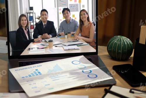 Preview: close up screen groupd of asian colleage video confernece business plan with laptop on table at home