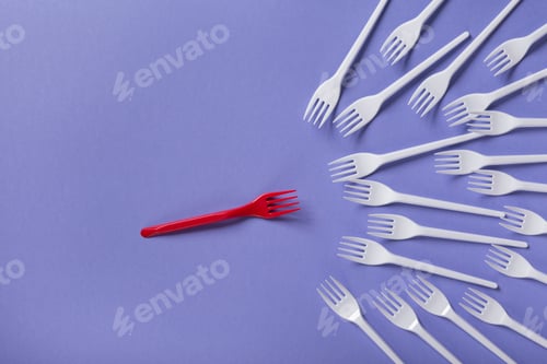Preview: Top view on plastic forks on violet background