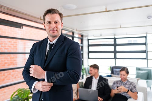 Preview: Smiling businesspeople having a discussion in an office