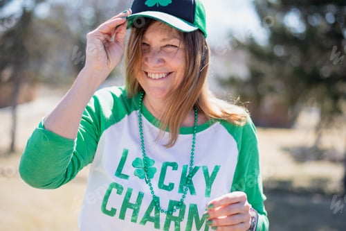 Preview: Woman laughing outside wearing festive outfit for St. Patrick’s day