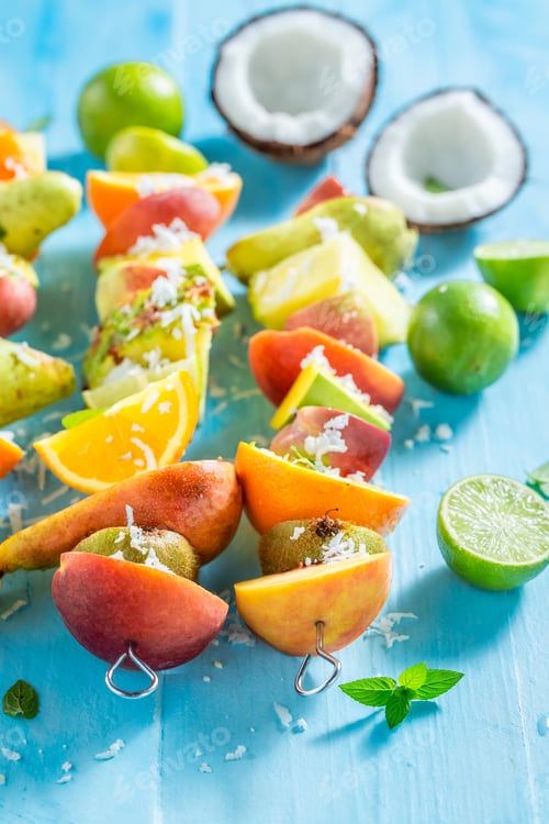 Preview: Colorful Tropical Fruit Skewers on Blue Background