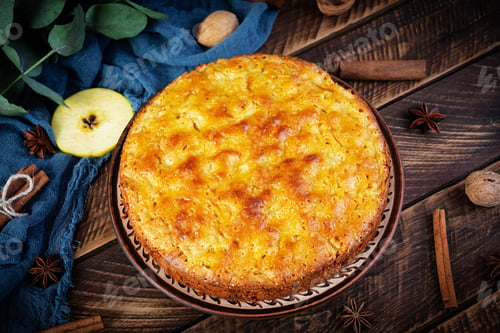 Preview: Delicious homemade apple pie on wooden background. Apple pie with ingredients, apples and cinnamon