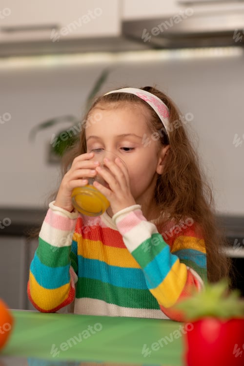 Preview: A cute little girl drink an orange fresh. Healthy eating. Family. Fresh fruit.