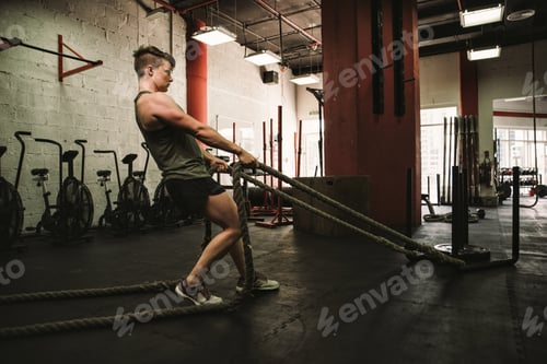 Preview: Beautiful young woman training at the gym
