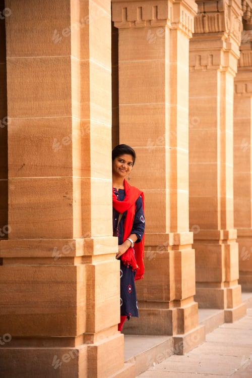 Preview: Indian woman standing between arches and Pillars.