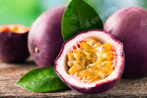 Preview: Fresh passion fruits and green leaves on wooden table outdoors, closeup
