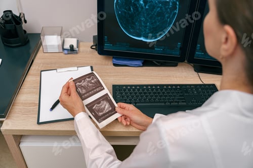 Preview: Back view of professional doctor radiologist analyzing scan MRI images in medical center