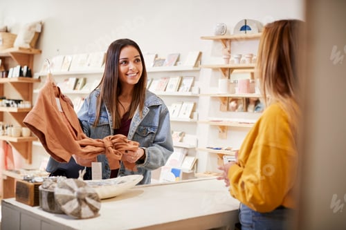 Preview: Female Sales Assistant In Independent Clothing And Gift Store Serving Female Customer