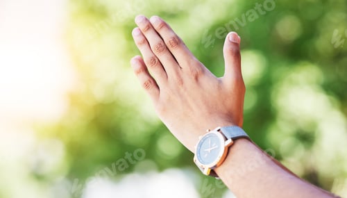 Preview: Hand, time and watch with a person outdoor in nature on a green background for freedom, meditation