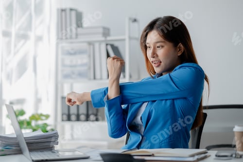 Preview: Asian woman in a startup company office, businesswoman poses stressed and body aches due to long hou