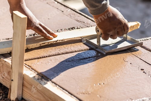 Preview: Construction Worker Using Hand Groover On Wet Cement Forming Coping Around New Pool