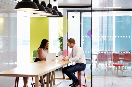 Preview: Man and woman having an informal meeting at work