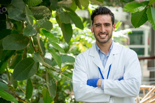 Preview: Biologist with arms crossed in a greenhouse