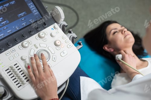 Preview: Ultrasound scanning diagnostic of woman thyroid gland in clinic, doctor runs ultrasound sensor