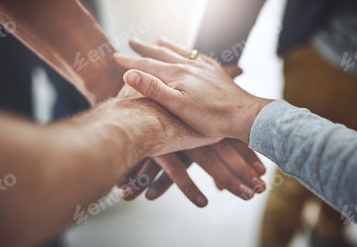 Preview: Closeup shot of a group of unidentifiable businesspeople joining their hands together in unity