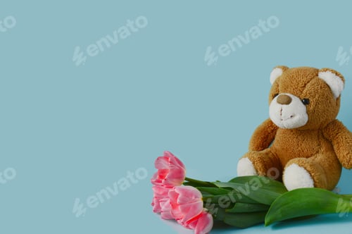 Preview: Beautiful pBeautiful pink tulips and a teddy bear on a blue background. Holiday on March 8, spring,