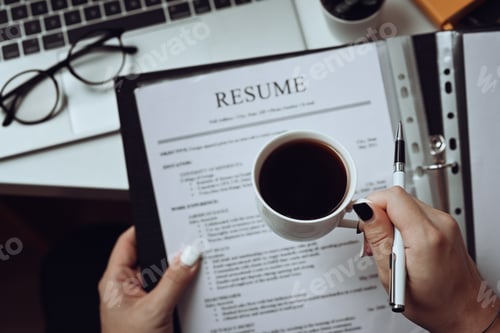 Preview: Close up view human resource manager reading CV resumes of job candidate.