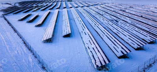Preview: Frozen photovoltaic farm at sunrise in winter, aerial view