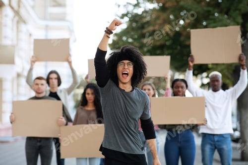Preview: Guy leading international group of students strikers with blank placards