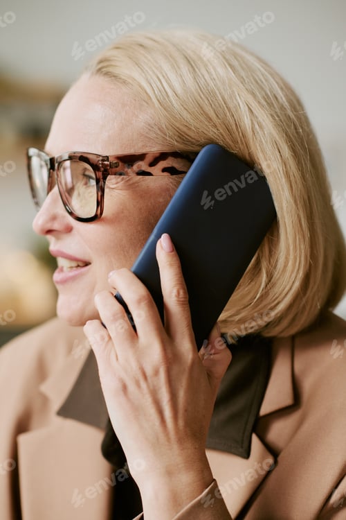 Preview: Middle Aged Woman Talking on Smartphone during Business Conversation