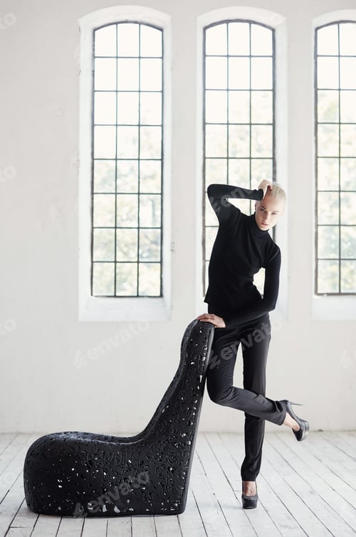 Preview: Female posing near artistic black chair.